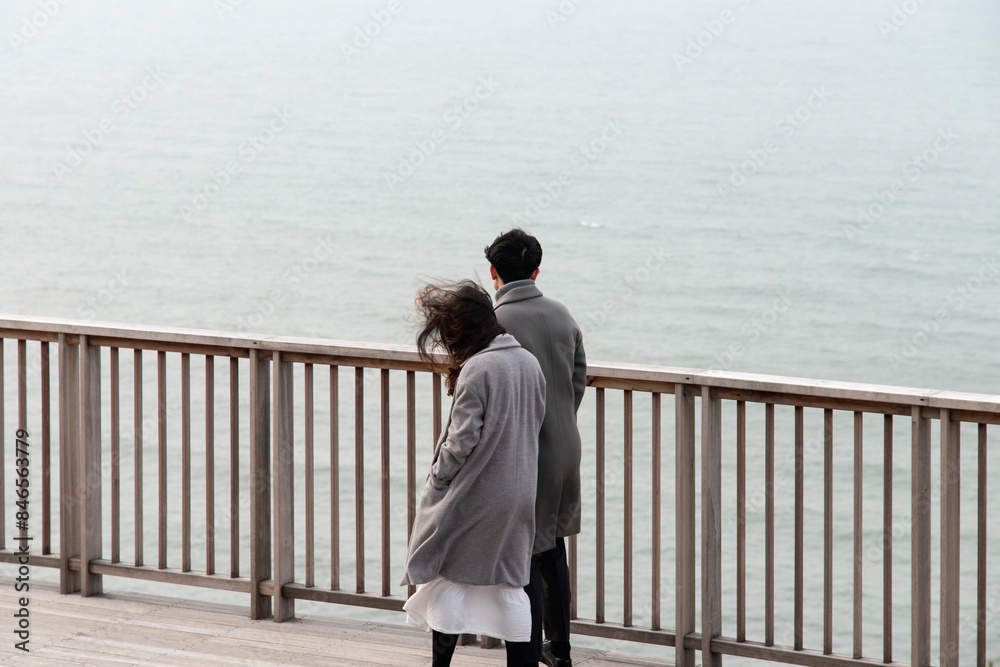 View of the couple in the wooden observatory at the seaside View of the couple in the wooden observatory at the seaside