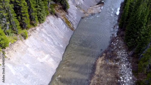 Small river flowing with trees beside it