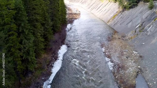 Small river flowing with trees beside it