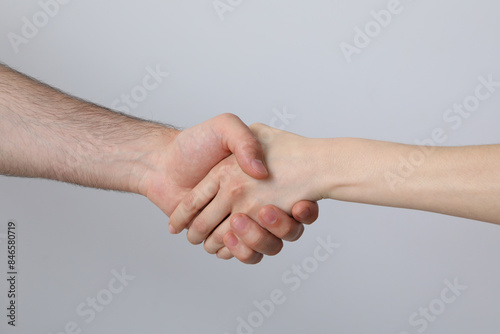 A female and a male hand make a handshake
