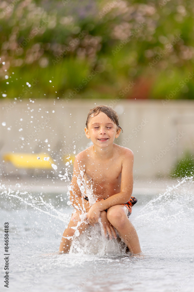 Cute child, boy in water park, having fun summertime Cute child, boy in water park, having fun summertime