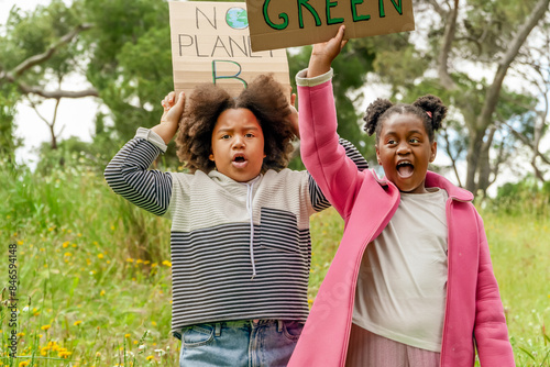 Young activists with environmental signs in a park photo