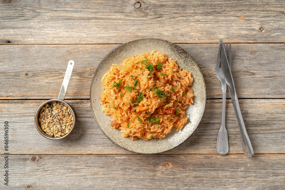 Rice with minced beef in tomato sauce in a plate. Top view
