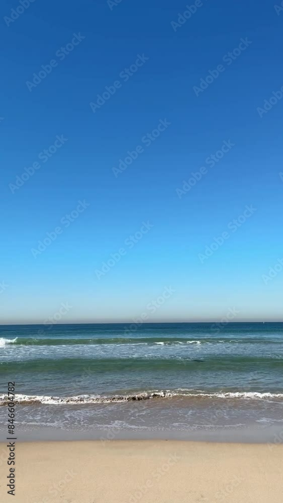 empty beach view with waves coming on sandy shore against clear blue sky with space for text empty beach view with waves coming on sandy shore against clear blue sky with space for text