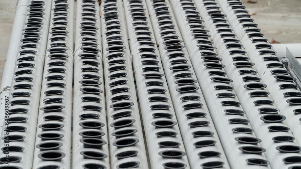 there are many holes in the white pipe for planting vegetable seeds