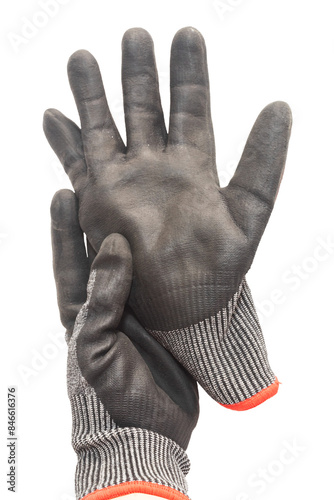 Hand wearing a black work glove holds another glove on a background. Working hand.