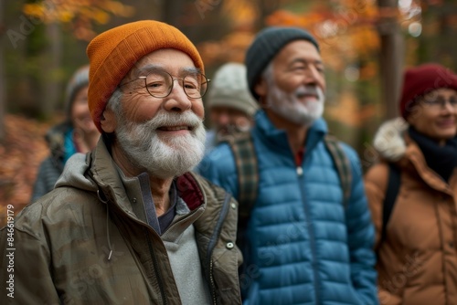 Group of senior friends spending time together in the park in autumn.