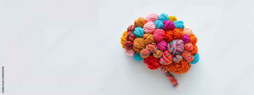 Human brain made from balls of yarn on the white background, banner with copy space, concept of neurodiversity and mental problems Human brain made from balls of yarn on the white background, banner with copy space, concept of neurodiversity and mental problems