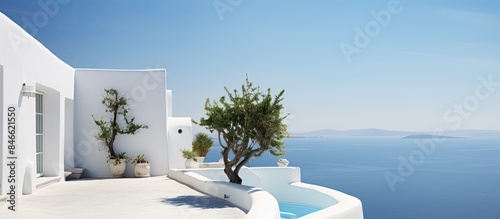 Fototapeta Naklejka Na Ścianę i Meble -  House with white Mediterranean walls, with the sea in the background on the islands, showcasing a picturesque view with copy space image.
