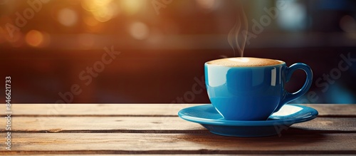 Blue cup of coffee on a woo...