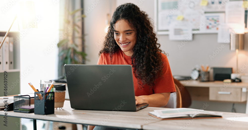 © peopleimages.com - Research, smile and woman at desk with laptop, communication and update in office. Female journalist, typing and happy at computer for article, social media and contact in modern workplace in city