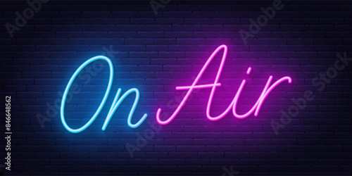 On Air Script Neon Sign on brick wall background.