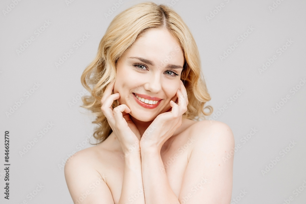 Close-up of a happy blonde girl showing a snow-white, beautiful smile against a light background. Concept of dental services and dental care products. Close-up of a happy blonde girl showing a snow-white, beautiful smile against a light background. Concept of dental services and dental care products.