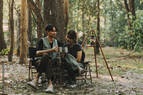 Asian couple sweet in tent inside on they camping trip, traveller relax and sleep togather in out door and camping trip photo