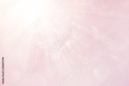Abstract light pink background with de focused sun light and bokeh effect
