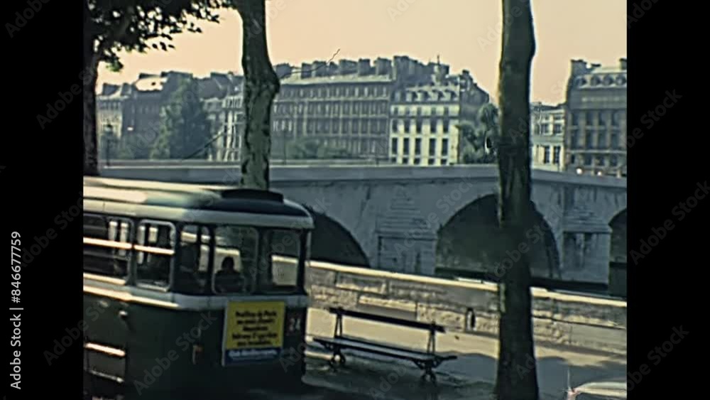 PARIS, FRANCE - CIRCA 1968: Palais Bourbon palace and road with vintage car and bus traffic at Pont Royal Bridge on Senna river, at Louvre Museum. Historic restored footage in 1960s.