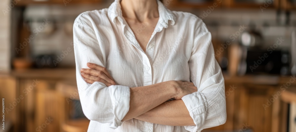 Obraz premium Confident young professional woman in white shirt, arms crossed, smiling indoors office
