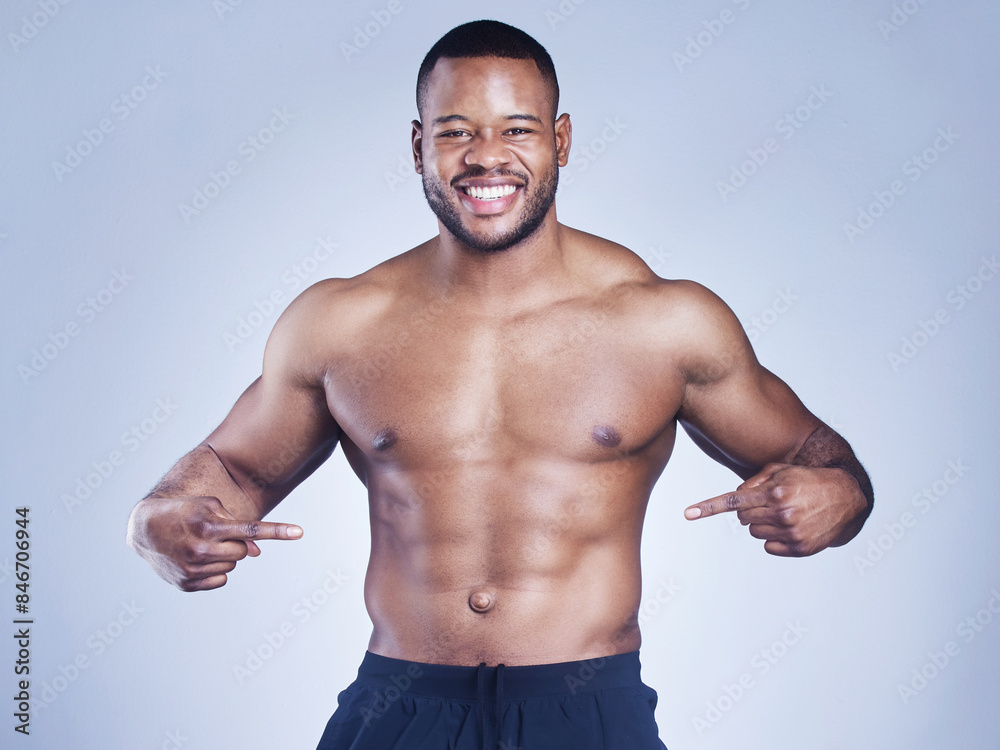 Fitness, portrait and black man with hand pointing to stomach in studio for training, wellness and abs progress on grey background. Sports, face and happy athlete show sixpack, growth and muscle flex Fitness, portrait and black man with hand pointing to stomach in studio for training, wellness and abs progress on grey background. Sports, face and happy athlete show sixpack, growth and muscle flex