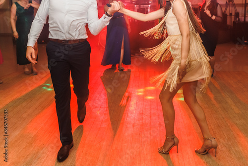 people dancing on the dance floor, party, men and women dancing, New Year's party, wedding party, birthday party , beautiful shapely legs, slender legs of dancers 