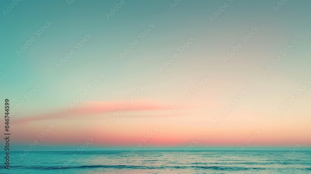 A beautiful blue ocean with a pink and orange sky