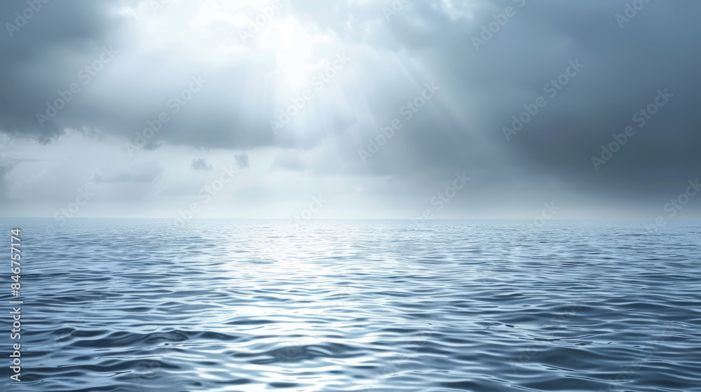 Serene ocean with rays of sunlight breaking through the clouds