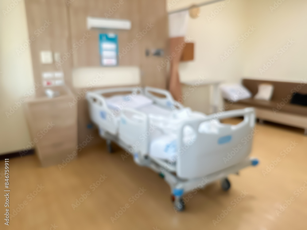 Blur image of Hospital bed in a luxurious and modern patient room. The atmosphere is clear and you can see the surrounding view Blur image of Hospital bed in a luxurious and modern patient room. The atmosphere is clear and you can see the surrounding view