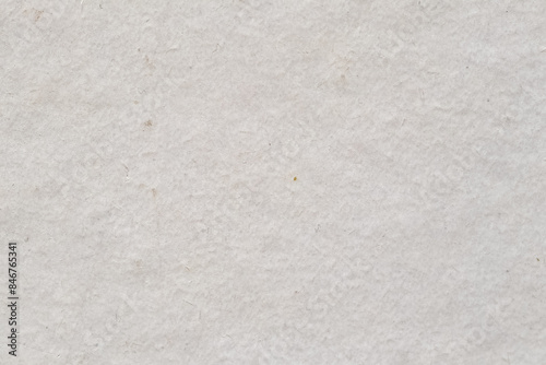 White rough cardboard paper texture background with imperfections, high detailed backdrop. Closeup macro shot