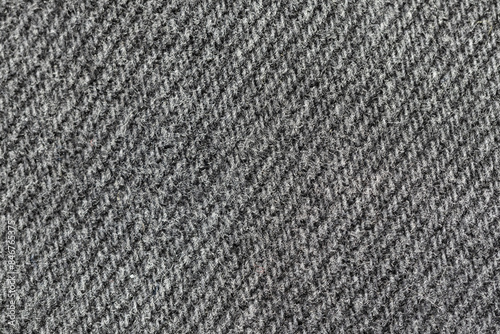 Black and grey denim background. High detailed backdrop texture of black and grey denim fabric. Closeup macro shot