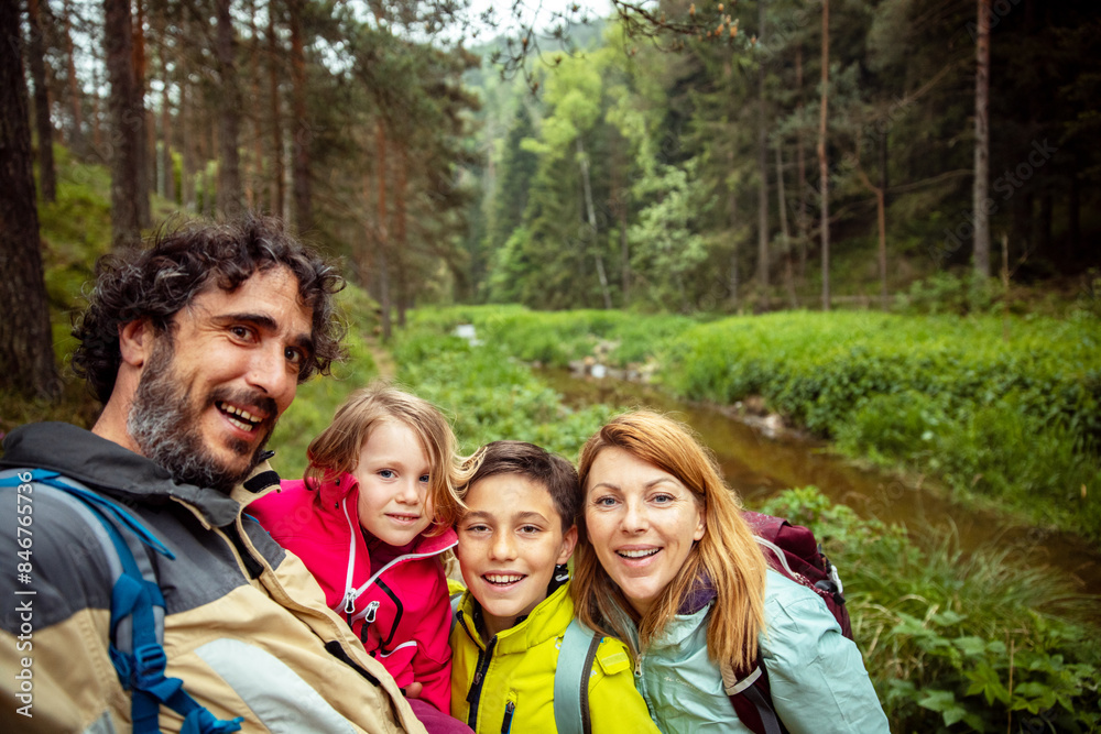 Happy family taking a selfie during a forest hike Happy family taking a selfie during a forest hike
