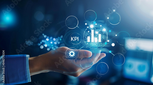 Businessman in suit holding glowing kpi icon in hand, business measurement technology result