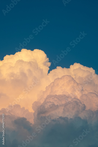 Evening dark blue sky with fluffy clouds
