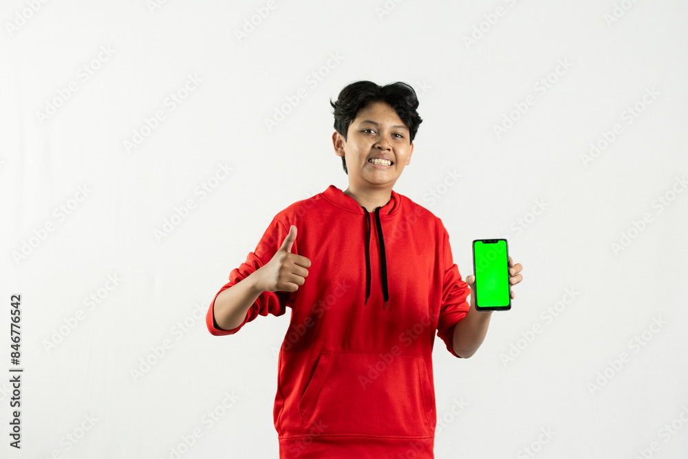 young asian man using his green screen cellphone to show something. independence day concept. isolated white background young asian man using his green screen cellphone to show something. independence day concept. isolated white background