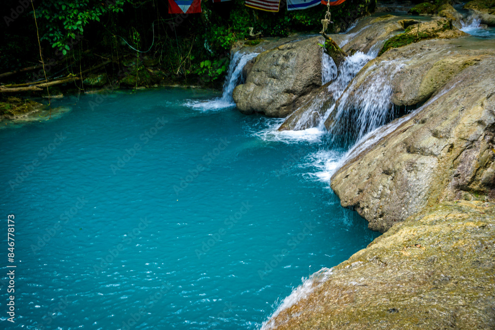 Blue Hole Waterfalls in Jamaica, pristine beautiful falls with vibrant blue and green colors. Blue Hole Waterfalls in Jamaica, pristine beautiful falls with vibrant blue and green colors.