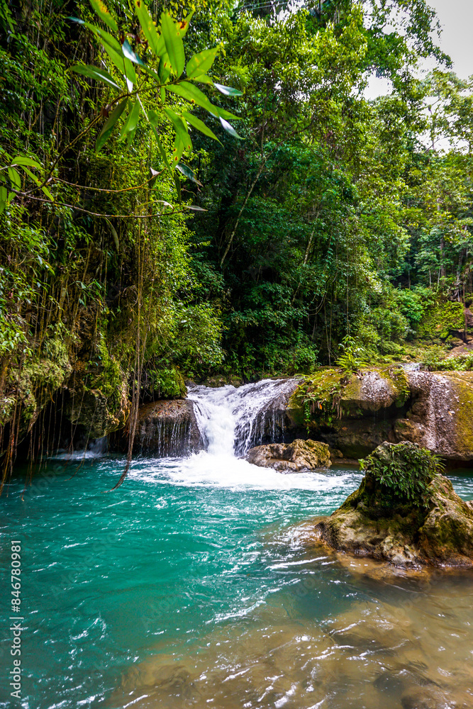 Naklejka premium in Jamaica a set of 7 different height and difficulty waterfalls with plentiful of ziplining, swimming and enjoyment.