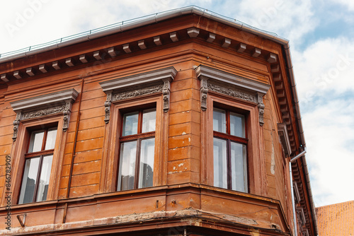 A historic redbrown building on a corner with ornate details and large windows, exuding elegance and charm photo