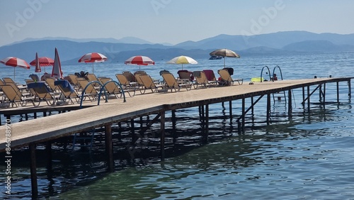 corfu island dassia beach tourist playing on the beach and the sea photo