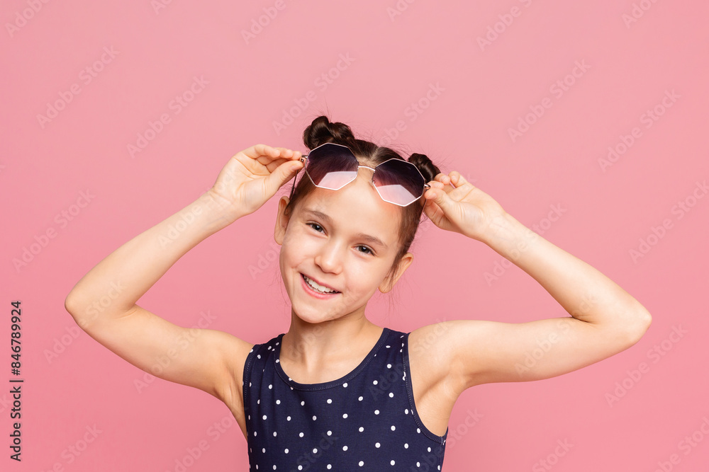 Adorable little girl wearing stylish sunglasses, pink panorama background Adorable little girl wearing stylish sunglasses, pink panorama background