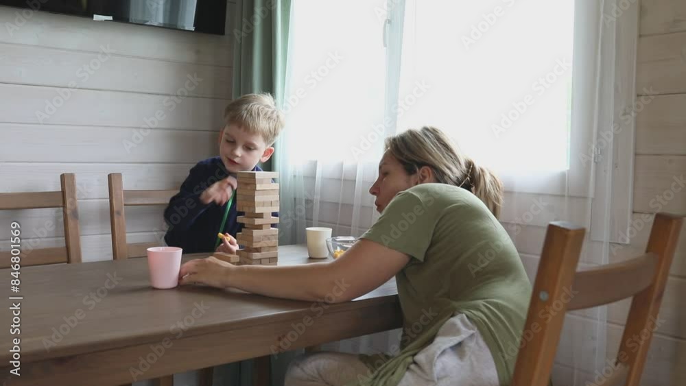 Mother and Son Playing Jenga at Home in the Afternoon Mother and Son Playing Jenga at Home in the Afternoon