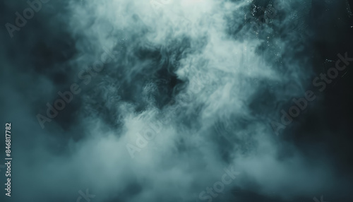 A pumpkin with a scary face is lit up and surrounded by smoke