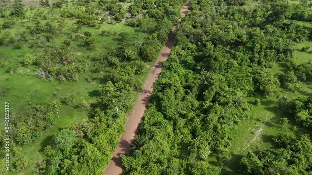 Aerial video over an African road surrounded by bushes and trees. Shai Hills Ghana Aerial video over an African road surrounded by bushes and trees. Shai Hills Ghana
