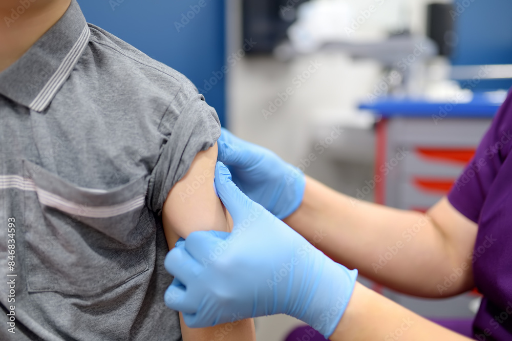 A boy is being vaccinated. A child is given a vaccine during an epidemic or outbreak of a disease. A boy is being vaccinated. A child is given a vaccine during an epidemic or outbreak of a disease.
