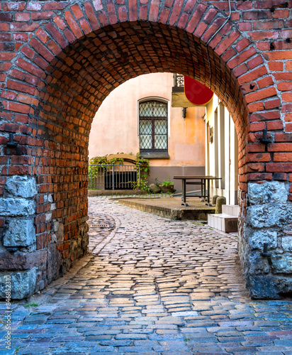 Medieval arch and entrance to the old district of town photo