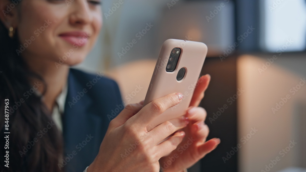 Smiling manager looking smartphone screen at modern office workplace closeup Smiling manager looking smartphone screen at modern office workplace closeup
