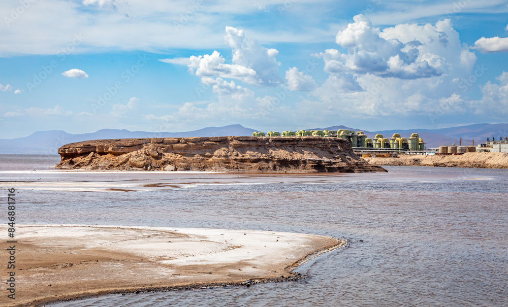 Lac Assal salt lake waters with salt extraction factory in the background, the lowest point of Africa, Tadjourah Region, Djibouti