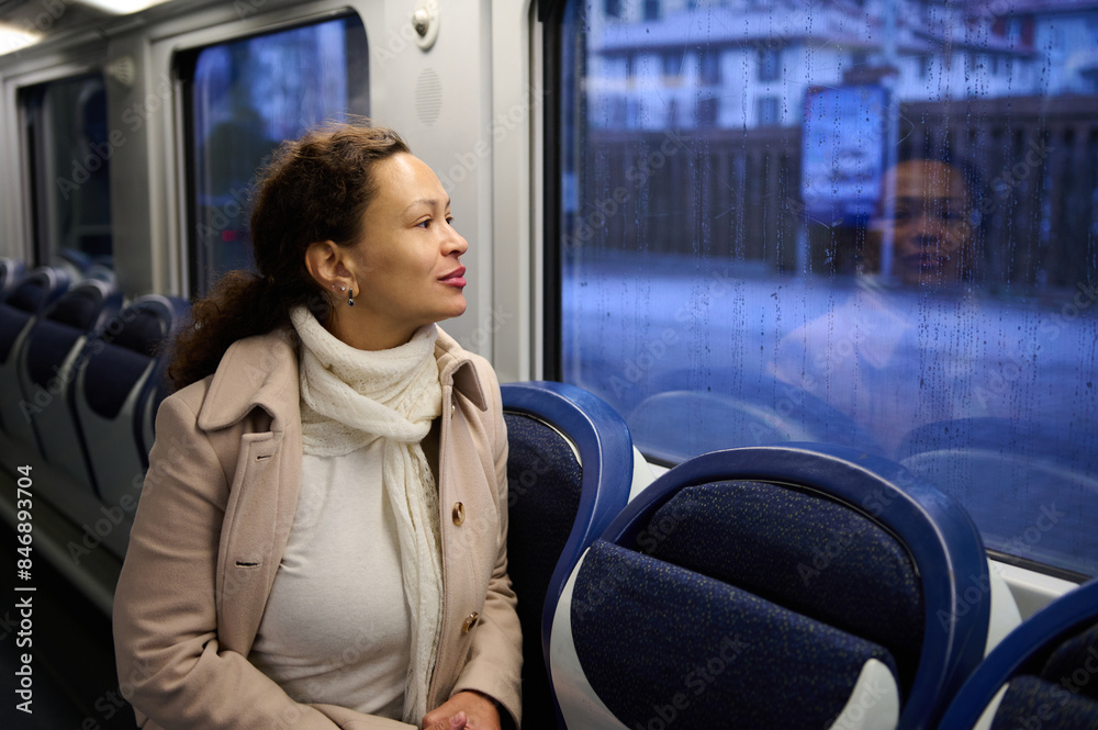 Woman looking out of a train window on a rainy day Woman looking out of a train window on a rainy day
