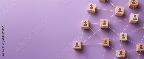 A visual metaphor for networking and team dynamics, featuring wooden blocks with human icons interconnected by lines on a purple backdrop. photo
