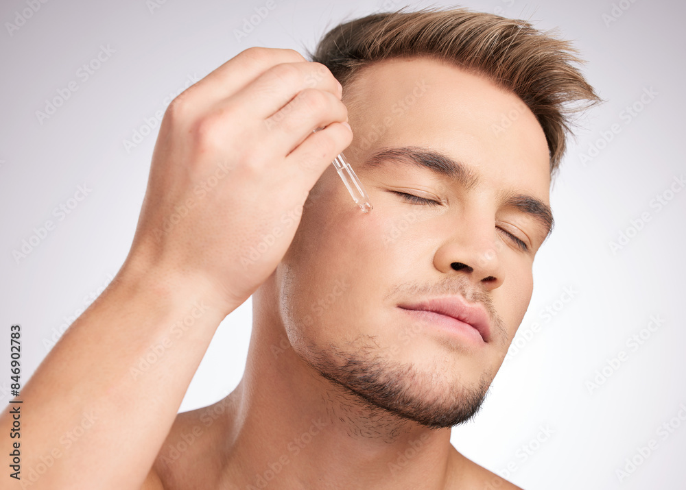 Cosmetics, man and liquid serum on face for skincare, wellness and hygiene in studio white background. Male person, health product and dermatology grooming for collagen treatment or essential oil Cosmetics, man and liquid serum on face for skincare, wellness and hygiene in studio white background. Male person, health product and dermatology grooming for collagen treatment or essential oil