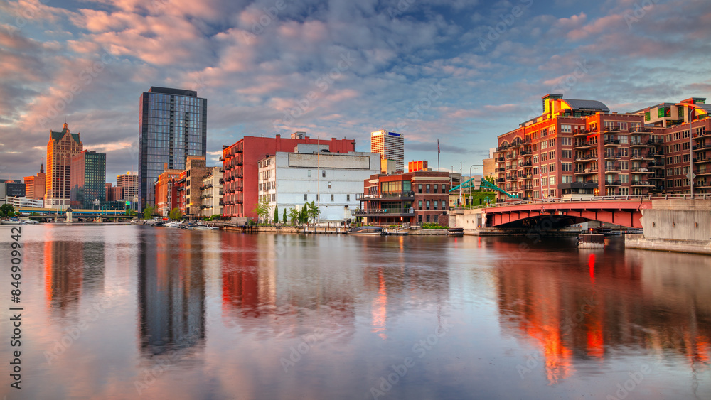 Milwaukee, Wisconsin, USA. Cityscape image of downtown Milwaukee, Wisconsin, USA with reflection of the skyline in Mnemonee River at summer sunset.