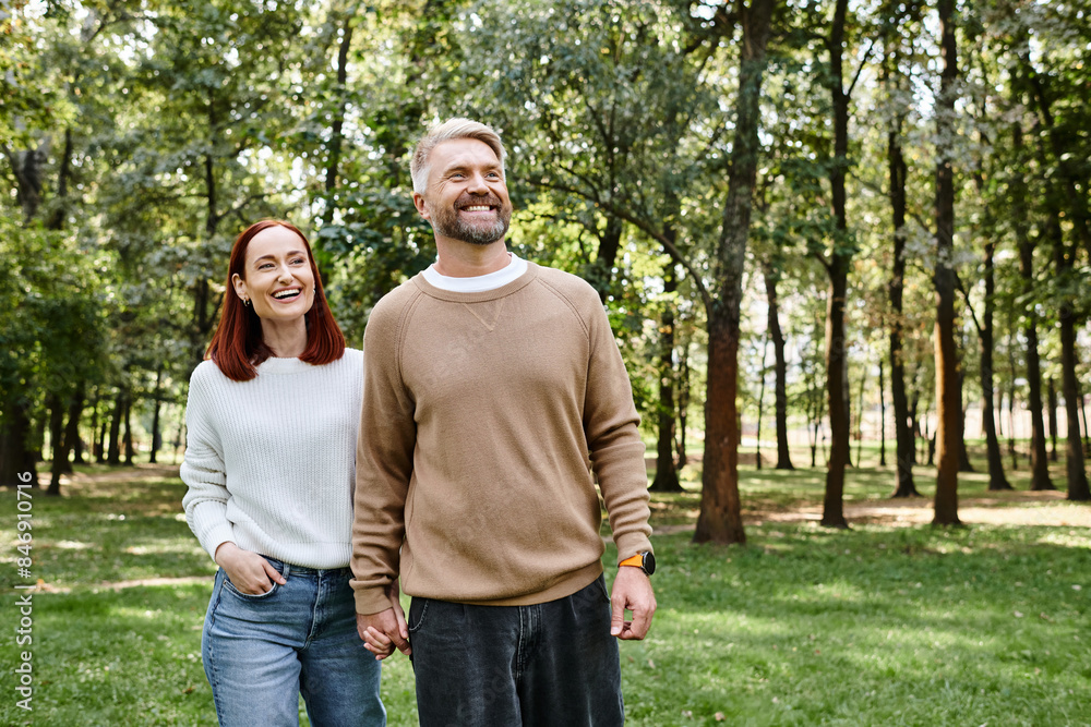 A man and a woman stand together in the lush green grass. A man and a woman stand together in the lush green grass.