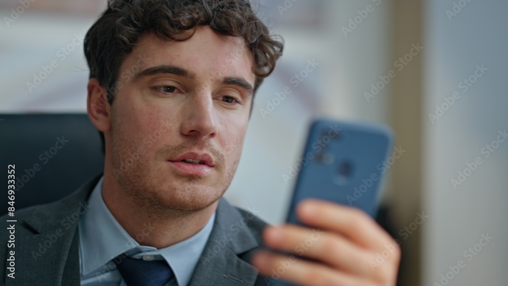 Attractive man reading smartphone sitting at buro closeup. Ceo surfing internet Attractive man reading smartphone sitting at buro closeup. Ceo surfing internet